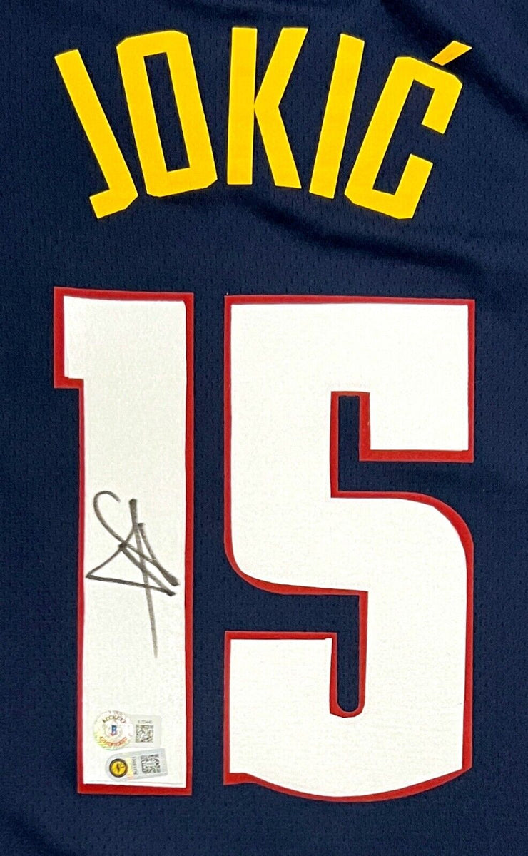 Nikola Jokic Denver Nuggets Unsigned Passing in Navy Jersey Photograph